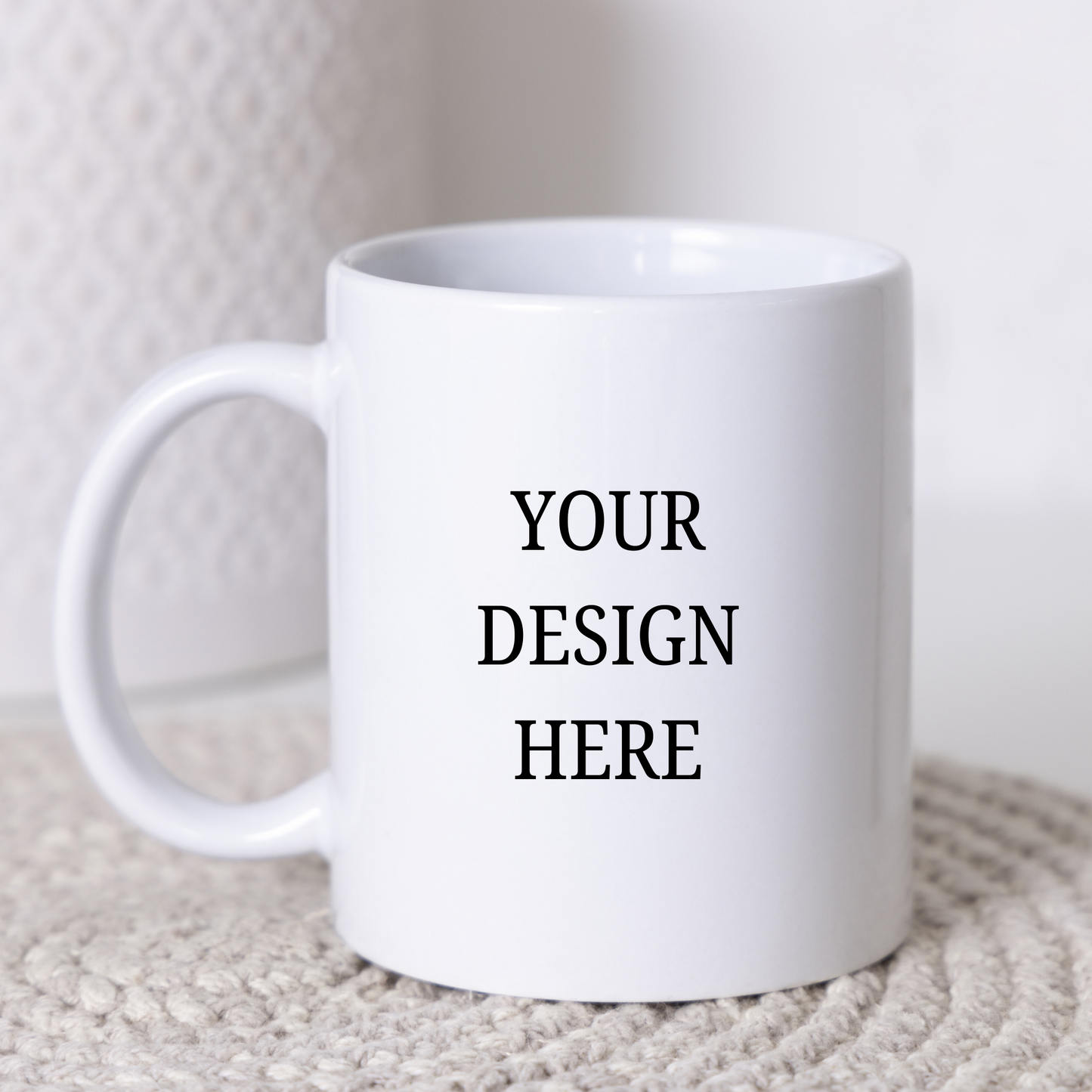 White mug with 'Your Design Here' text on a neutral background