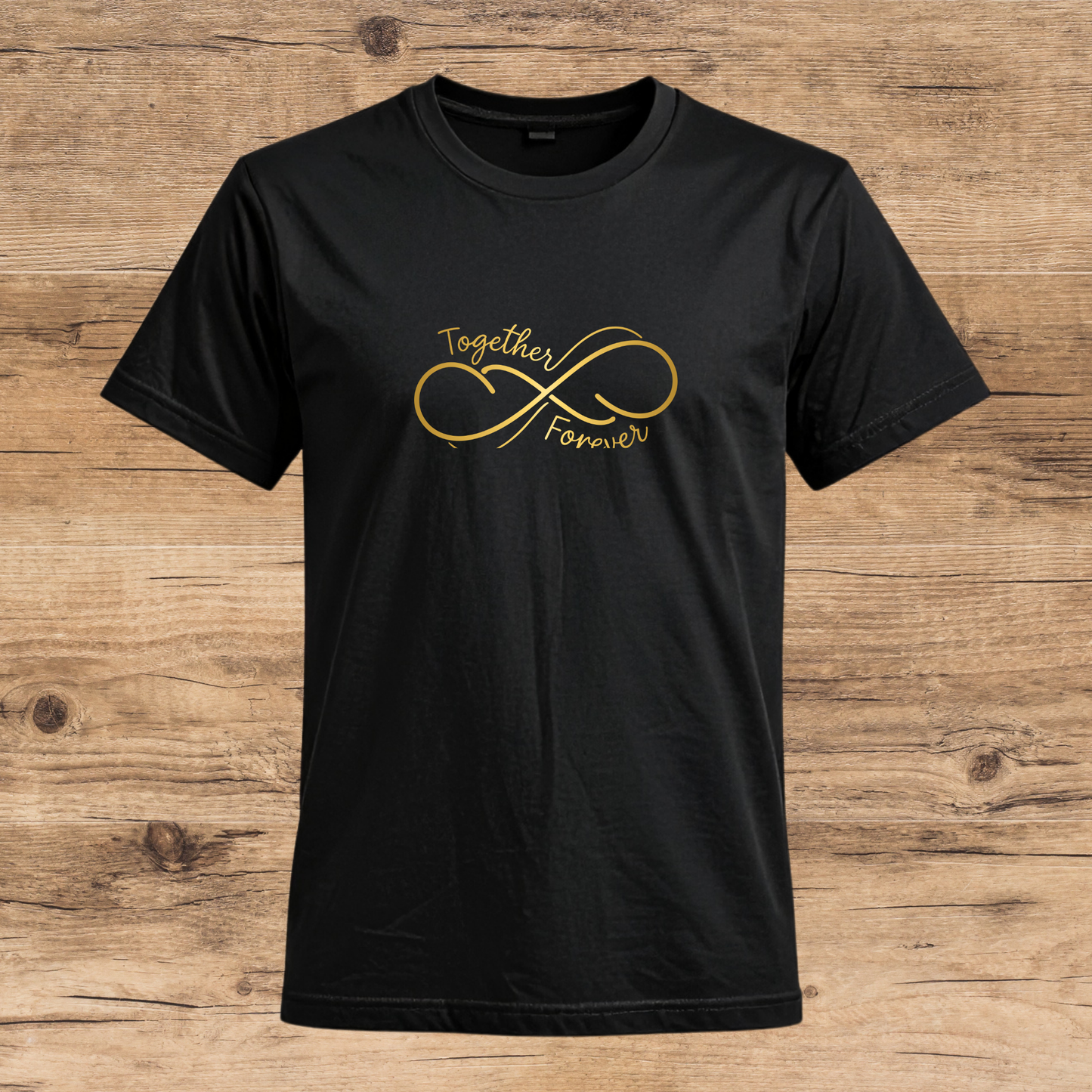 Black t-shirt with gold infinity symbol and text on a wooden surface