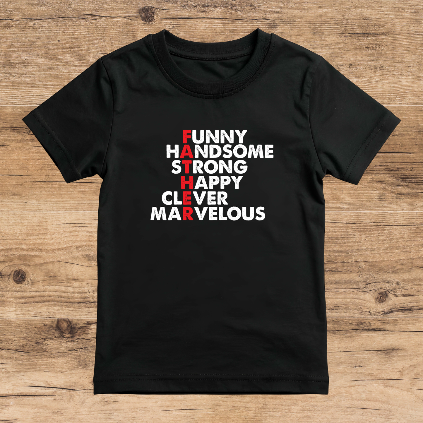 Black t-shirt with motivational text on a wooden surface