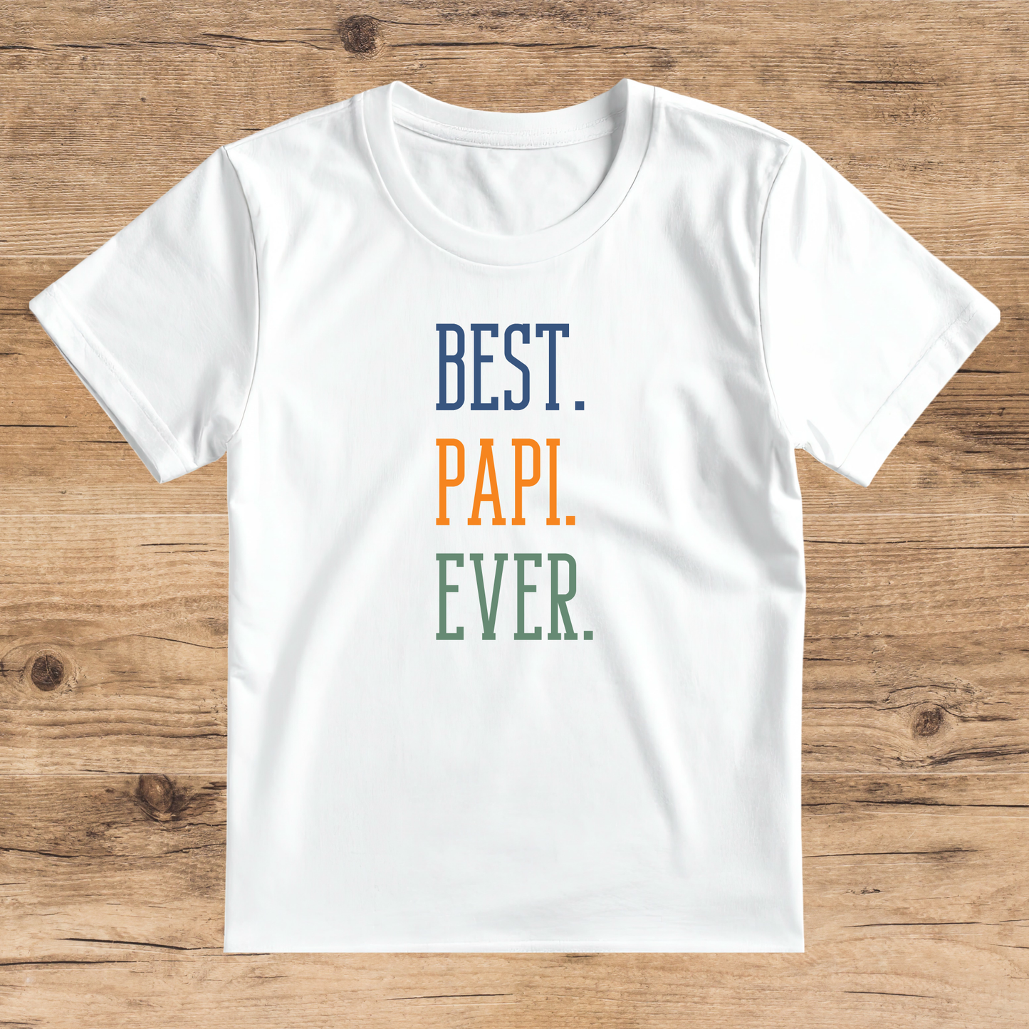 White t-shirt with 'BEST. PAPI. EVER.' text on a wooden surface