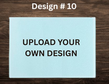 Placeholder design with text 'UPLOAD YOUR OWN DESIGN' on a light blue card against a wooden background.