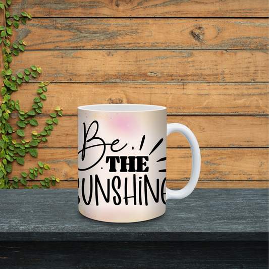 Mug with 'Be the Sunshine' text on a wooden background
