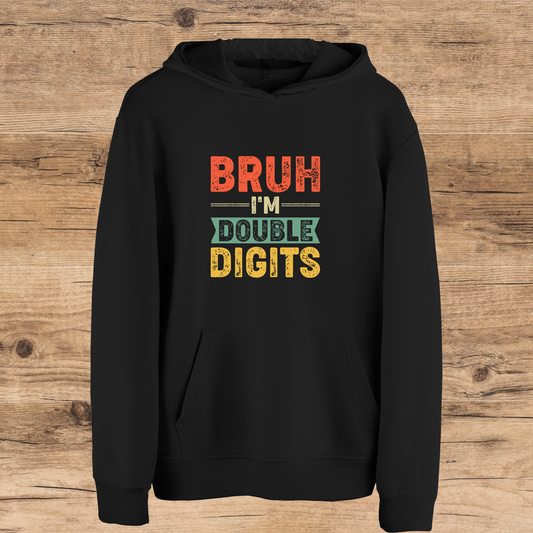 Black hoodie with colorful text on a wooden surface