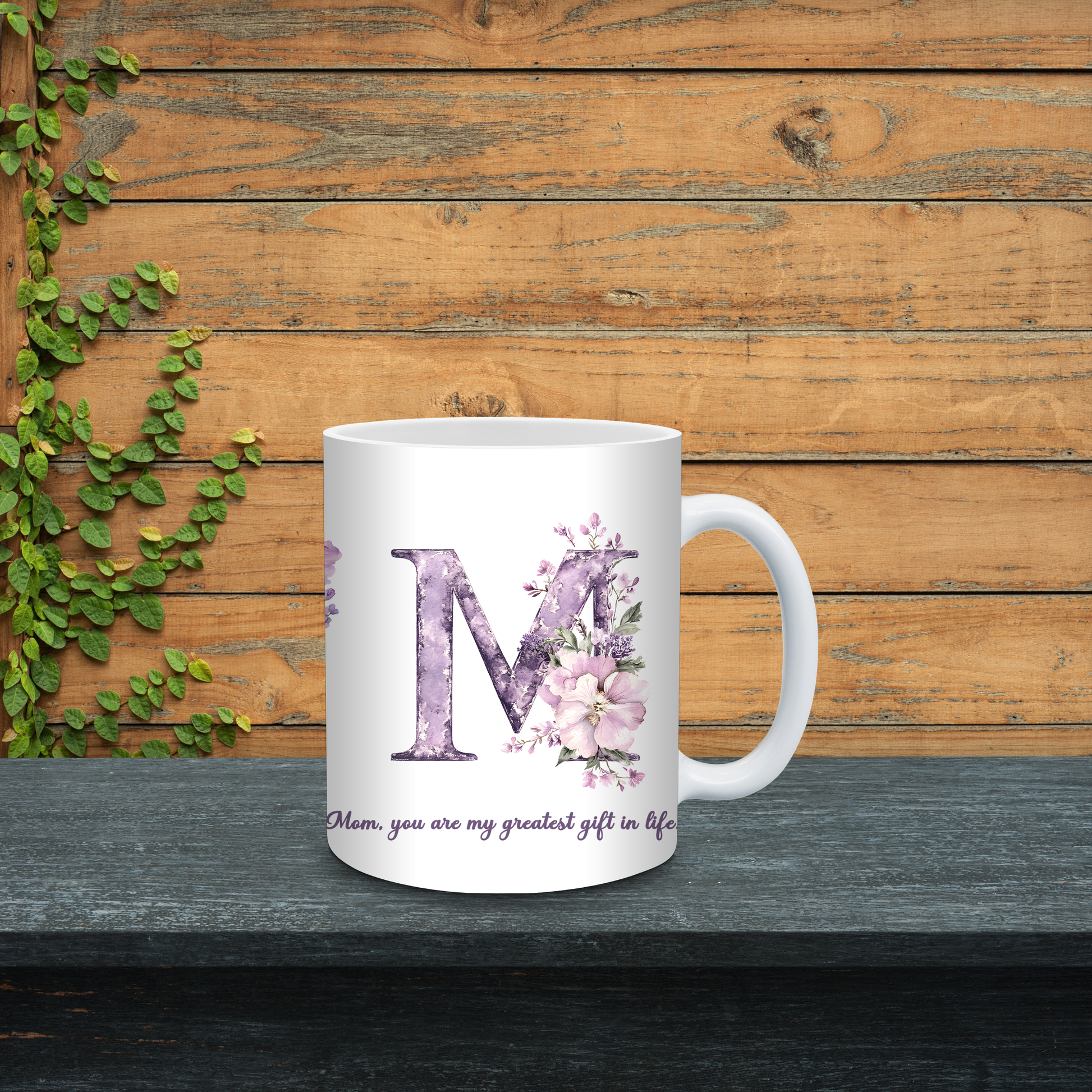 White mug with purple letter 'M' and floral design on a wooden background