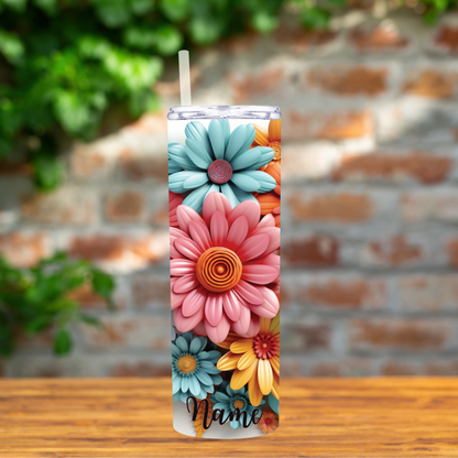 Tumbler with floral design and 'Name' text on a wooden surface with a brick wall background