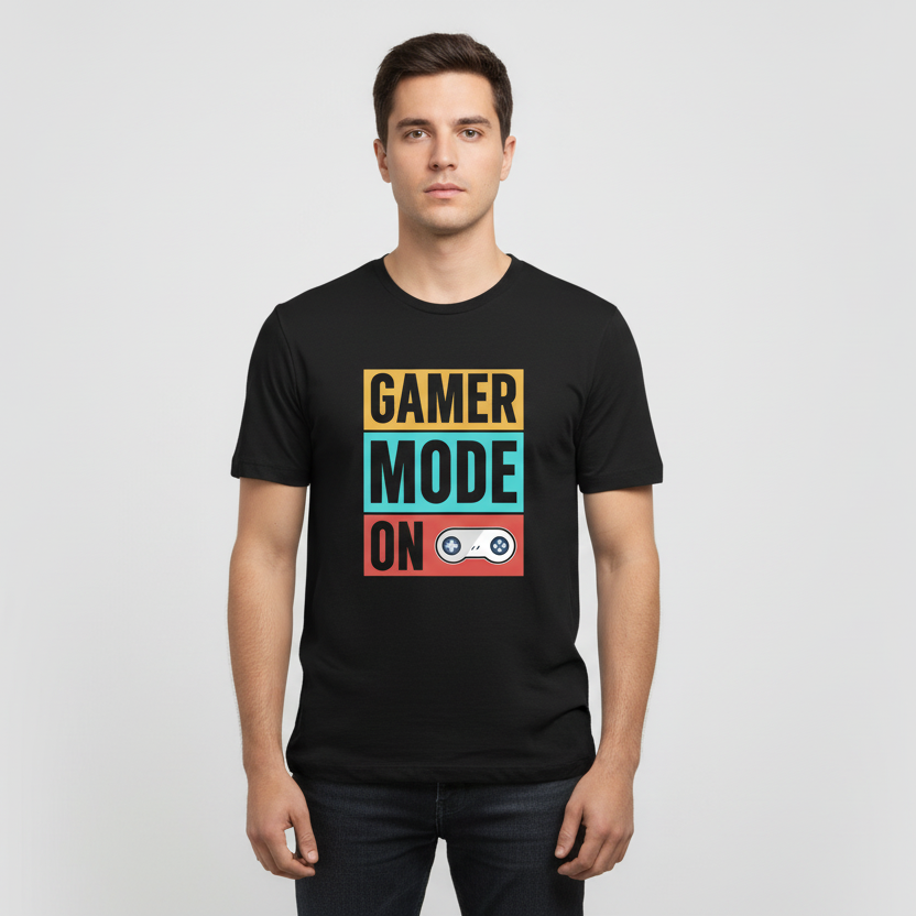 Black t-shirt with 'Gamer Mode On' text and graphics on a wooden surface