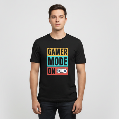 Black t-shirt with 'Gamer Mode On' text and graphics on a wooden surface