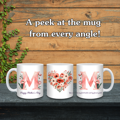 Three white mugs with floral designs and letters 'M' on a wooden background.