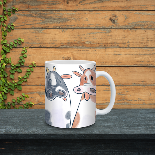 White mug with cow design on a wooden surface