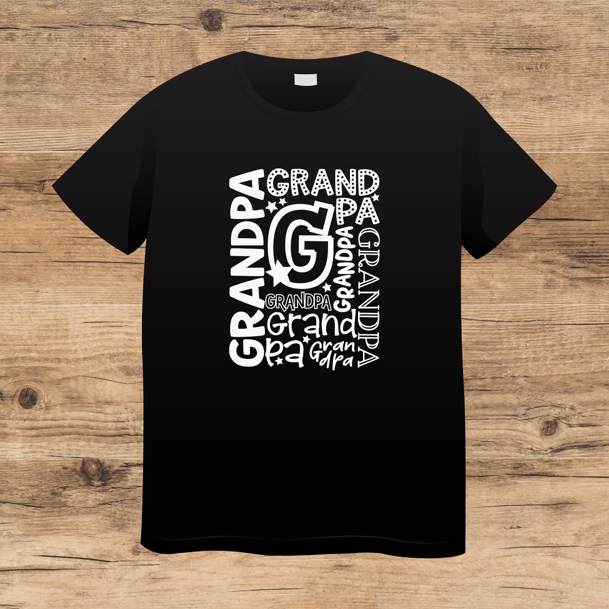 Black t-shirt with 'GRANDPA' text design on a wooden surface