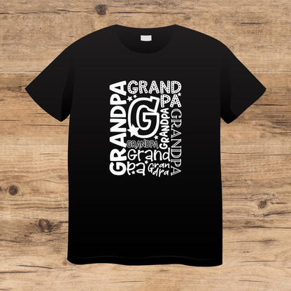 Black t-shirt with 'GRANDPA' text design on a wooden surface