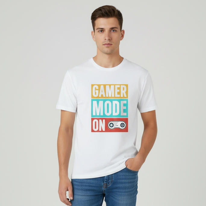 White t-shirt with 'Gamer Mode On' text design on a wooden surface