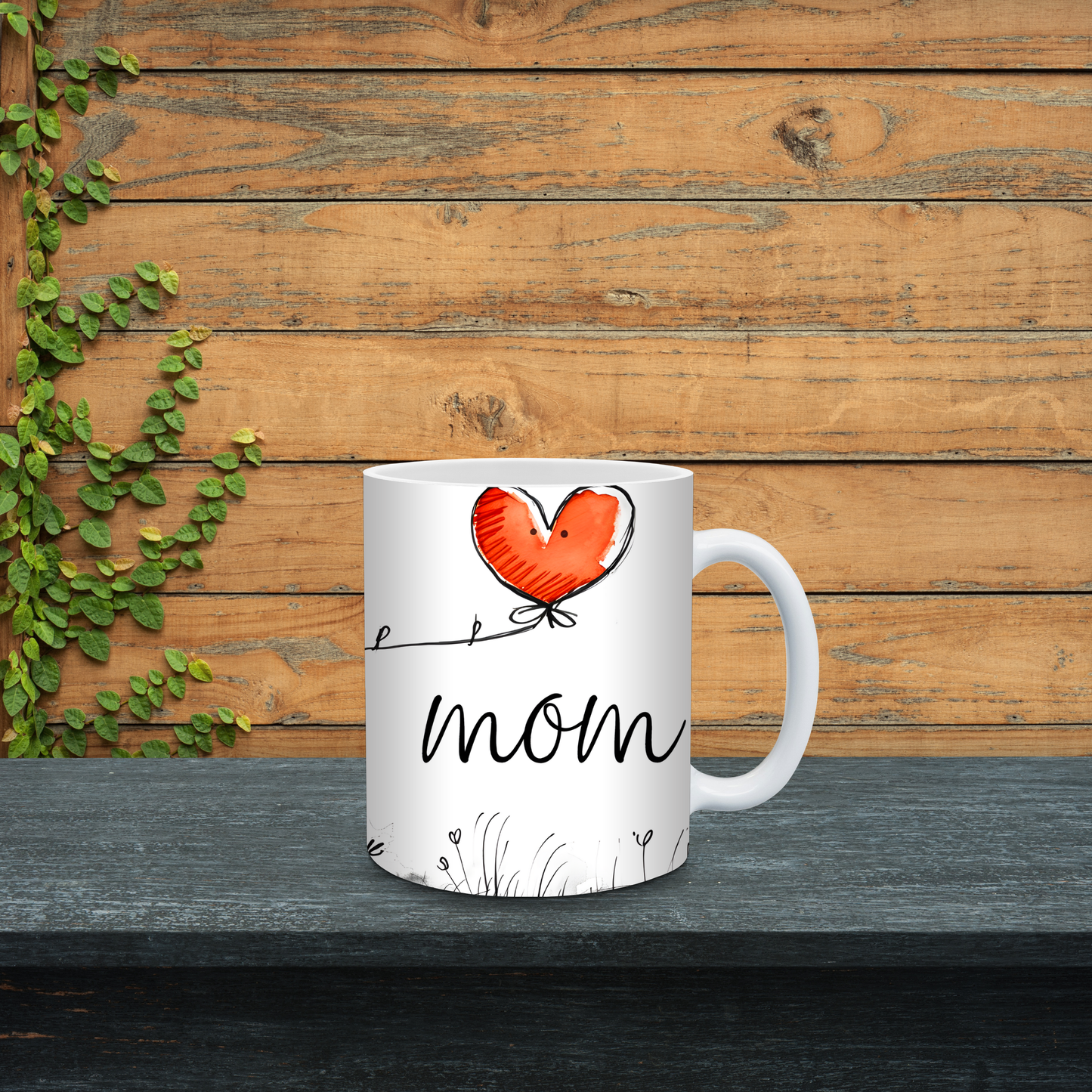 White mug with red heart and 'mom' text on a wooden background
