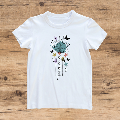 White t-shirt with floral design and 'mama' text on a wooden surface