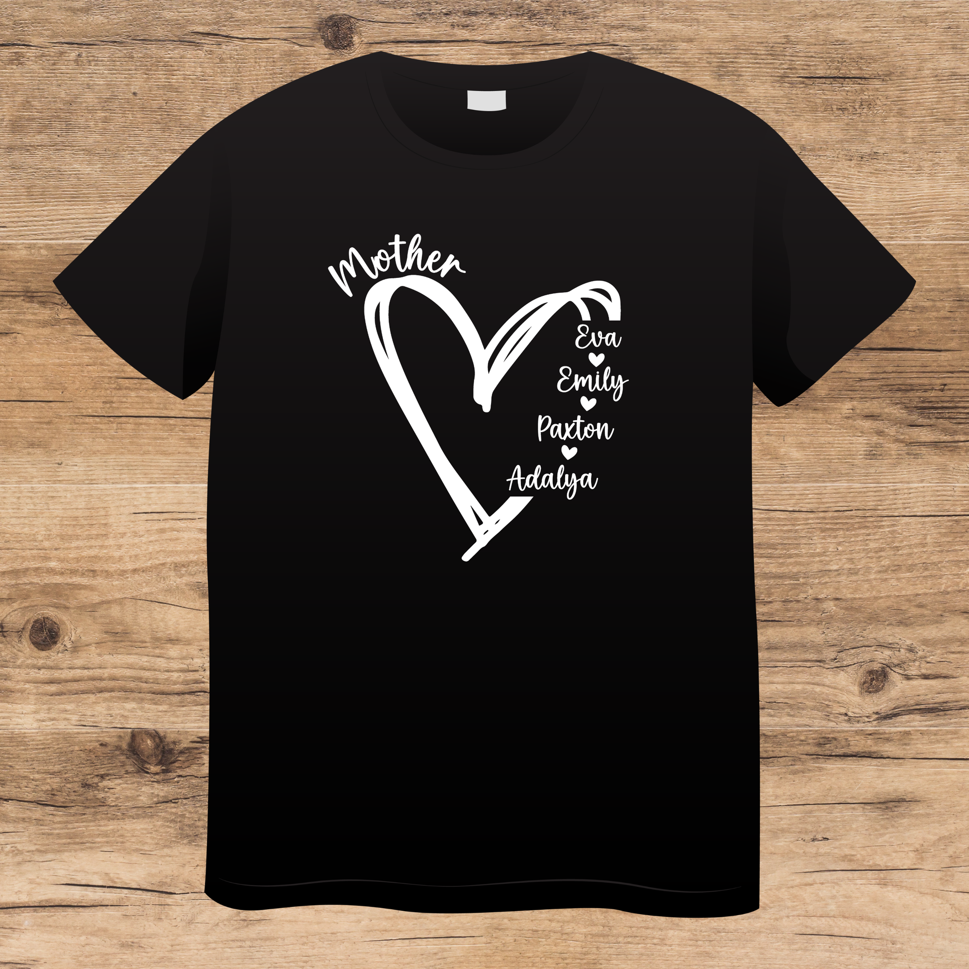 Black t-shirt with white heart design and names on a wooden surface