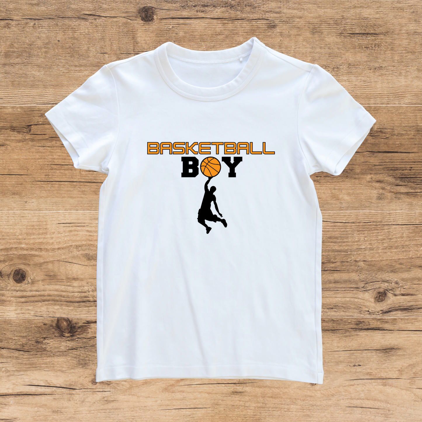 White t-shirt with 'Basketball Boy' graphic on a wooden surface