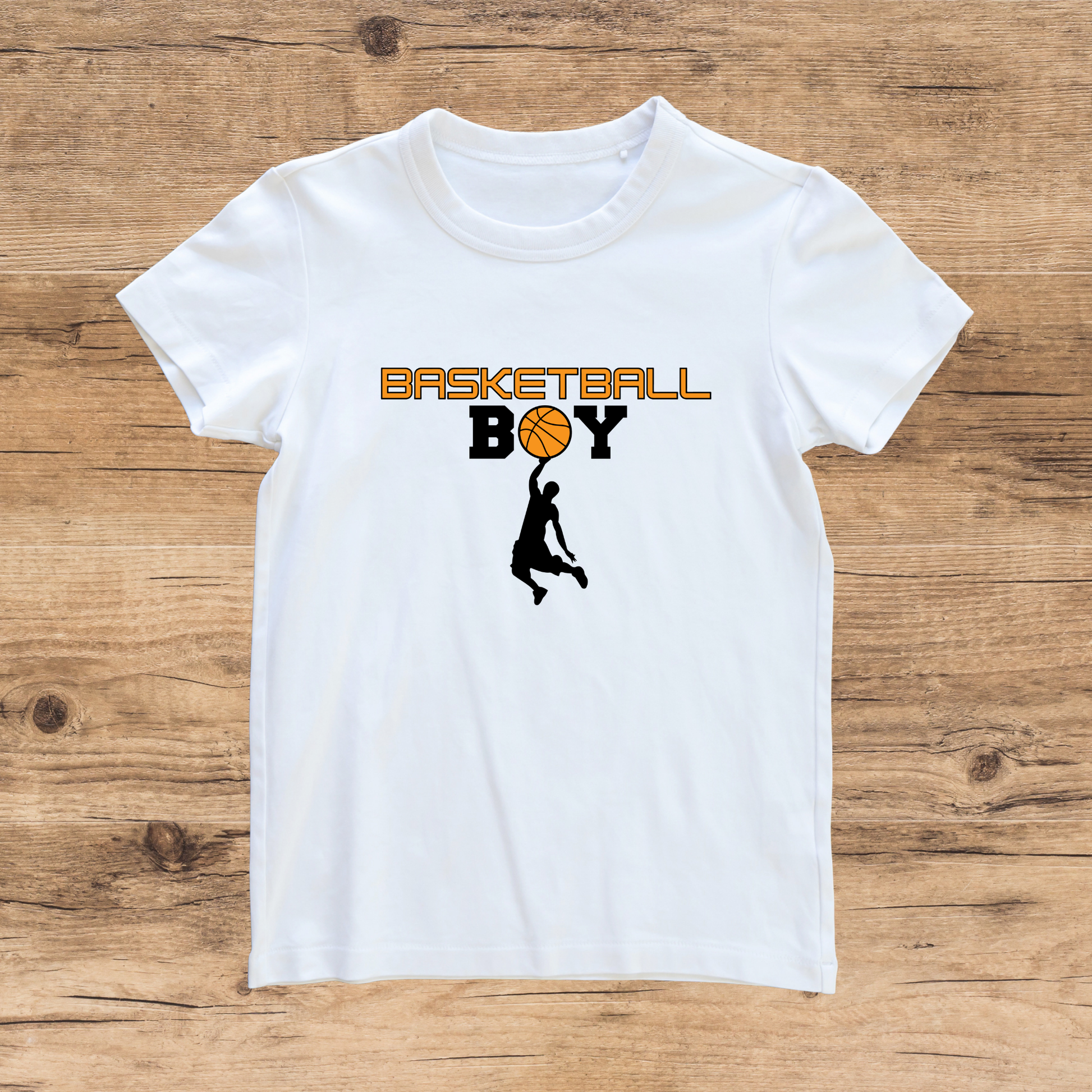 White t-shirt with 'Basketball Boy' graphic on a wooden surface