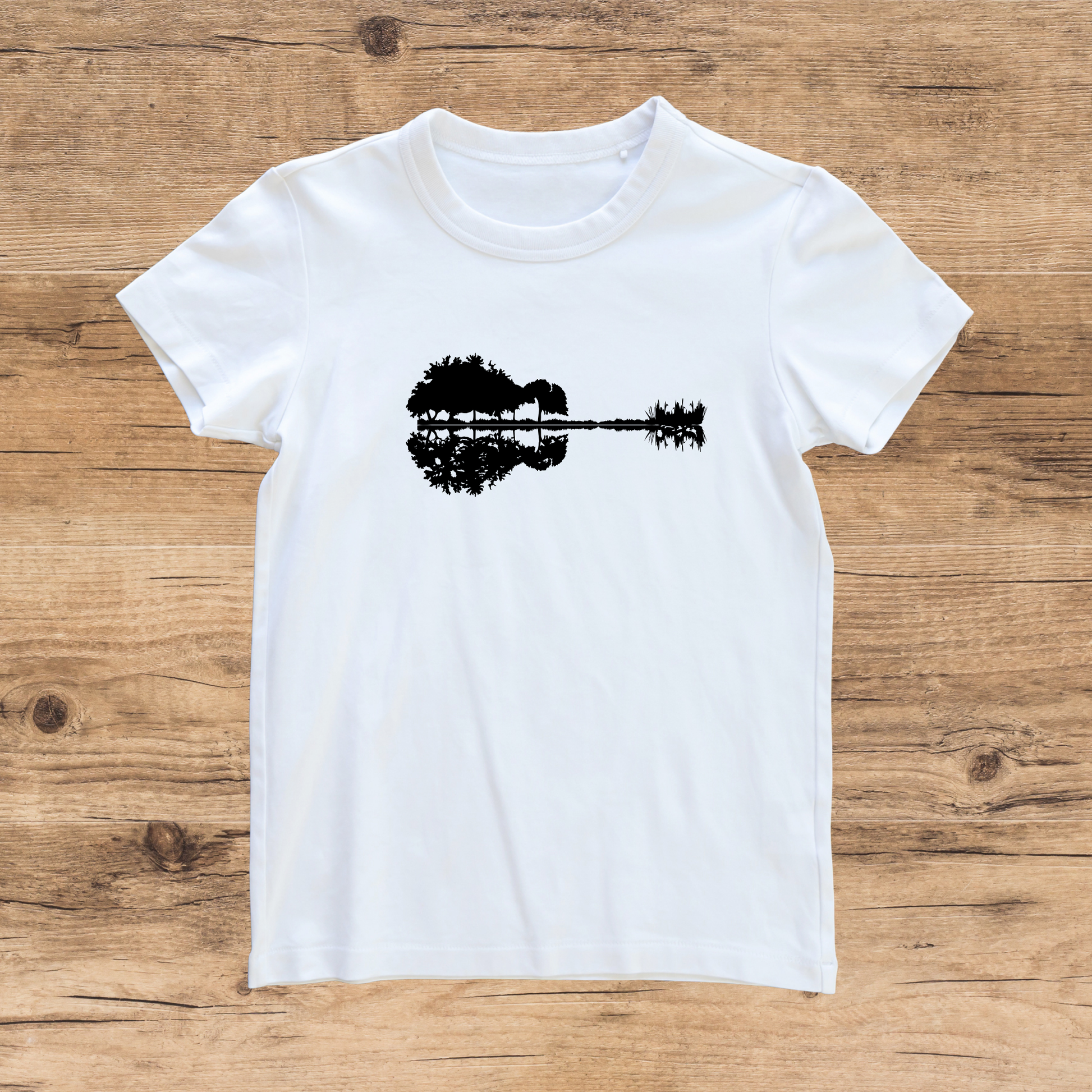 White t-shirt with black graphic on a wooden surface