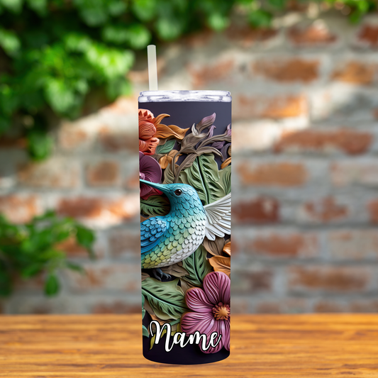 Tumbler with a colorful hummingbird and floral design on a brick background
