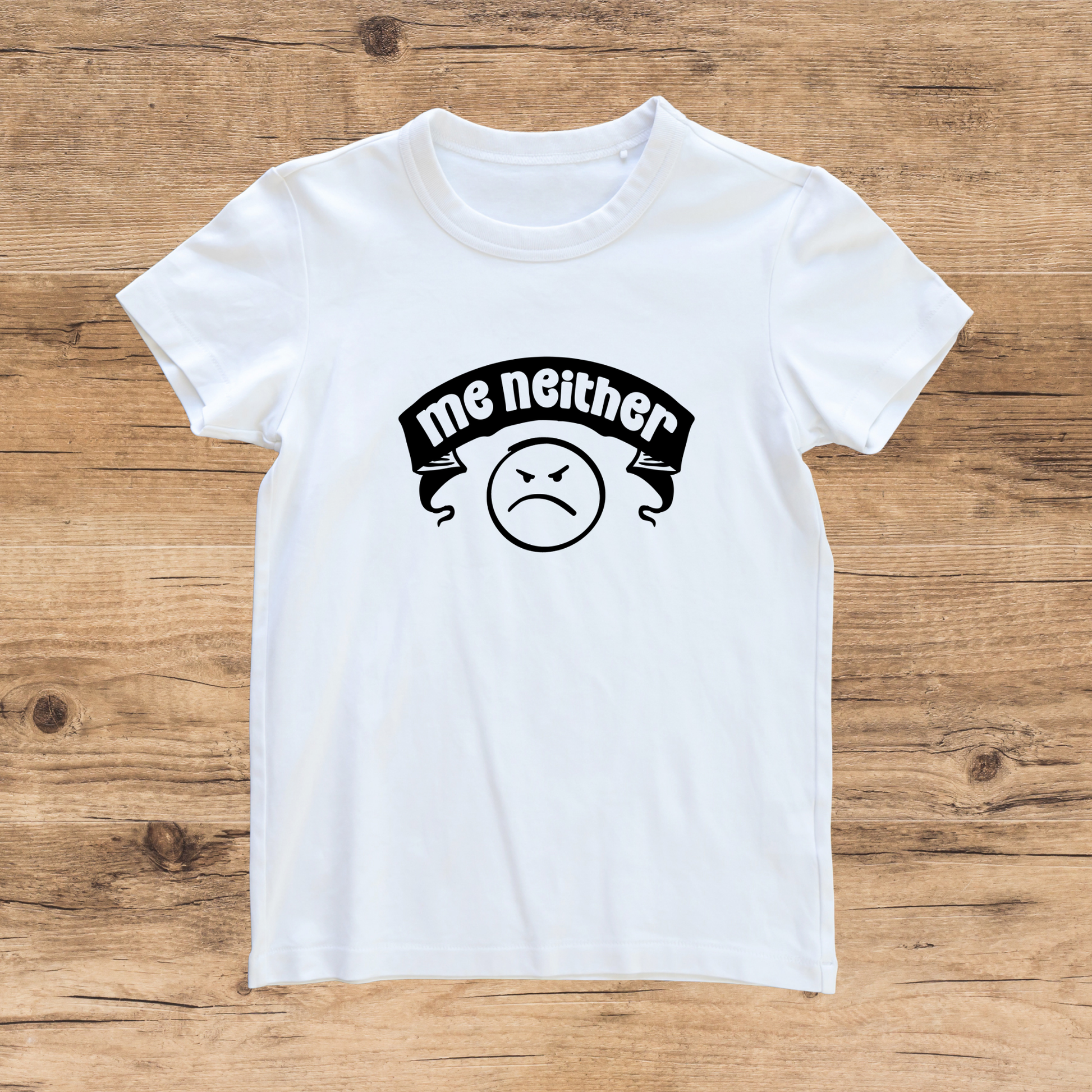 White t-shirt with a graphic design on a wooden surface