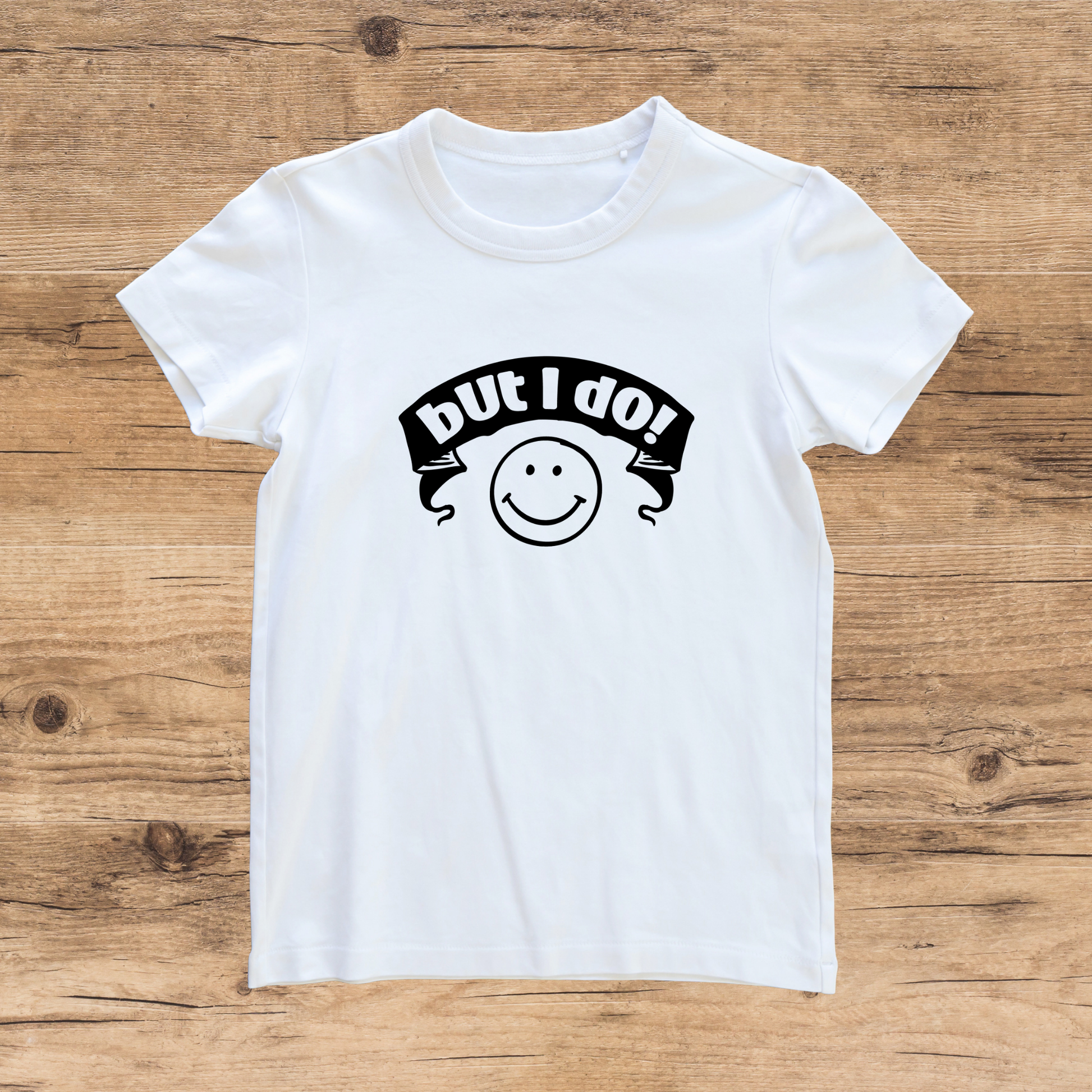 White t-shirt with a black graphic design on a wooden surface