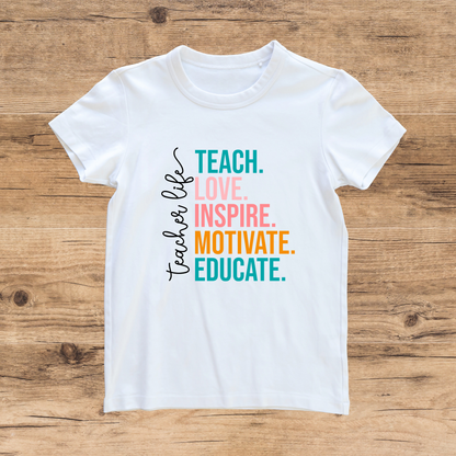 White t-shirt with colorful text on a wooden surface