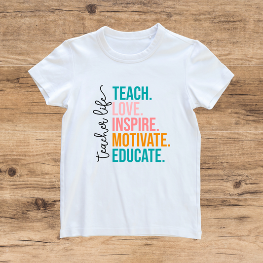 White t-shirt with colorful text on a wooden surface