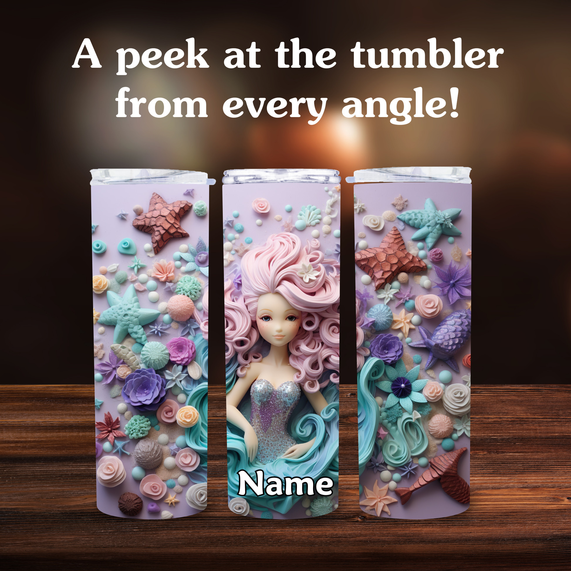 Three decorative tumblers with a mermaid design on a wooden surface.