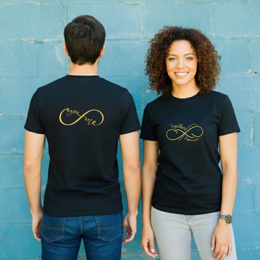 Two people wearing black t-shirts with gold text against a blue wall.