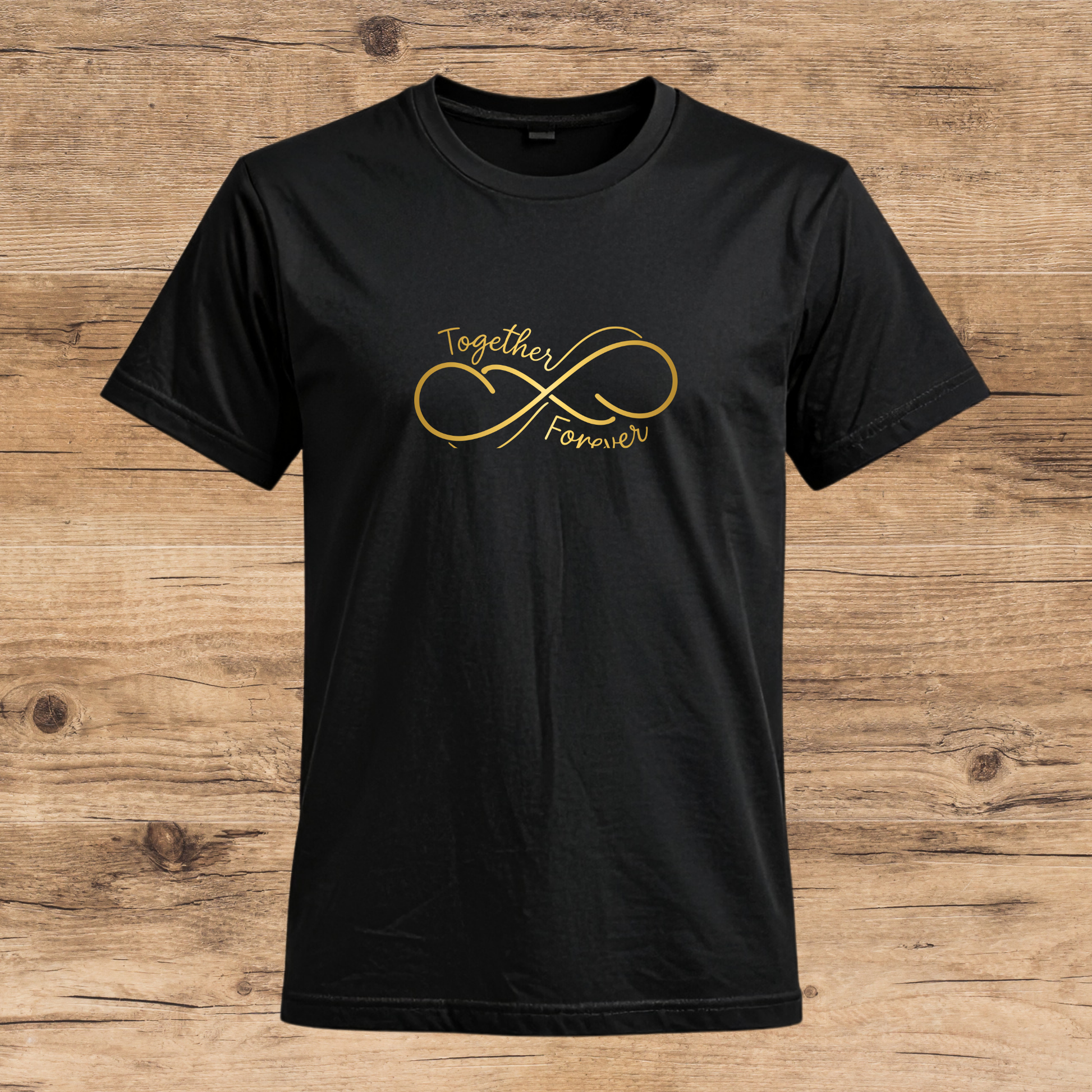 Black t-shirt with gold infinity symbol and text on a wooden surface