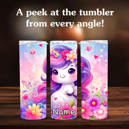 Three colorful tumbler designs with a cartoon unicorn and floral elements on a wooden surface.