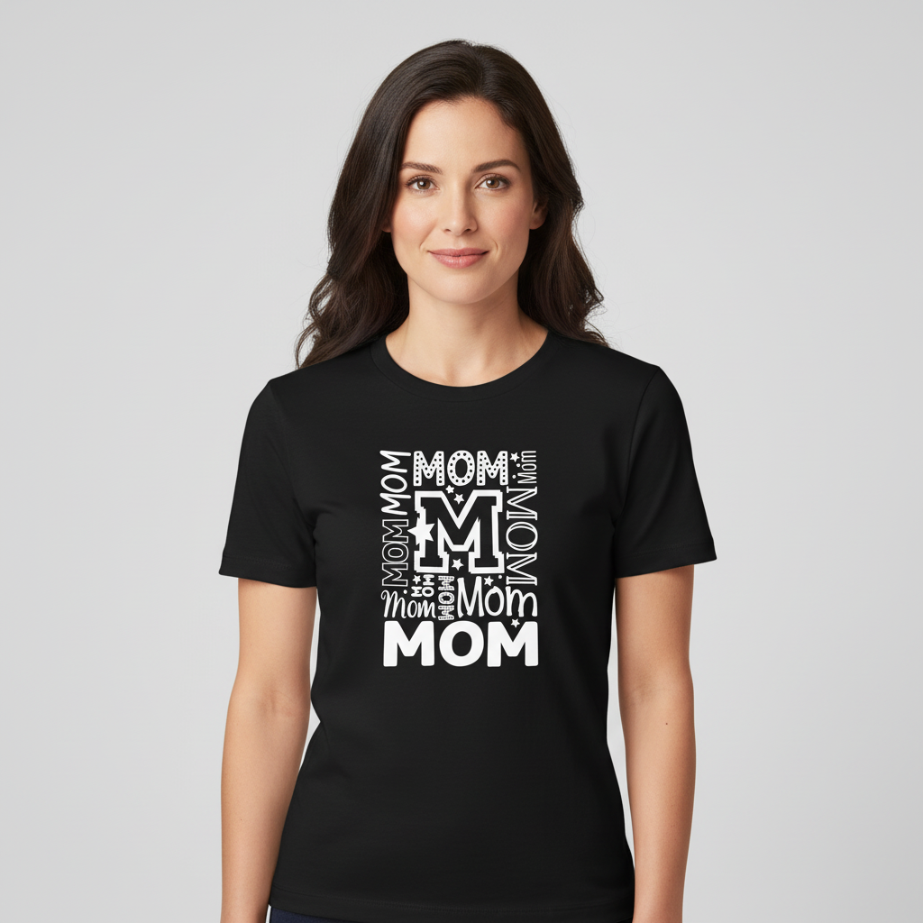 Black t-shirt with white 'Mom' text design on a wooden surface