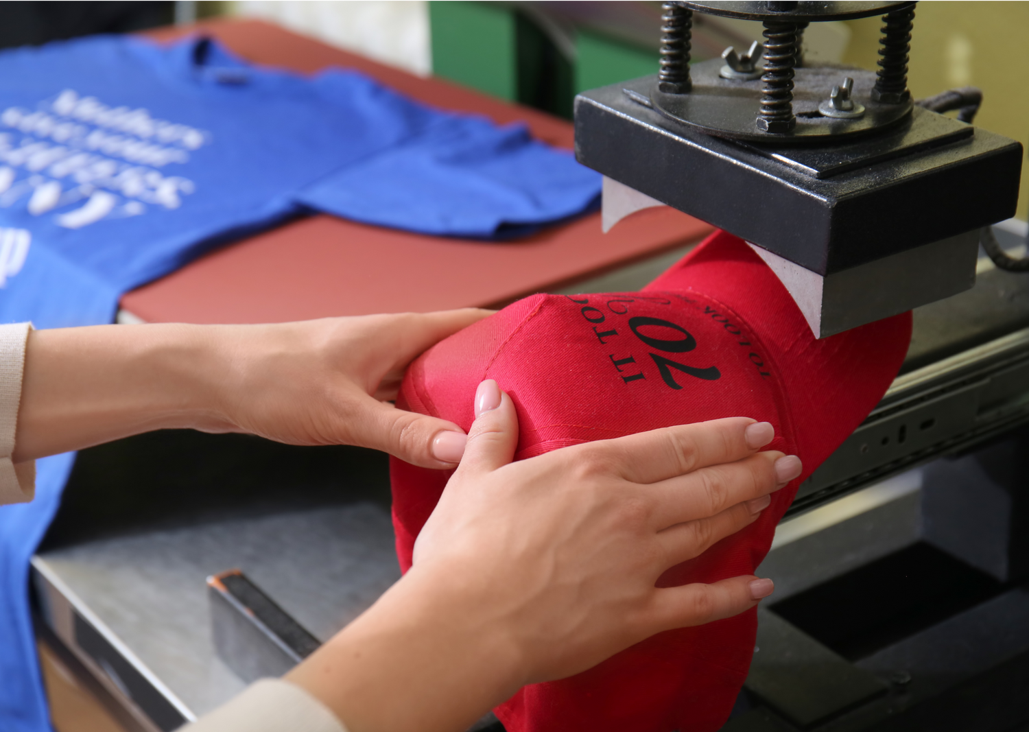 Person doing customization Printing on T-shirts and Caps.