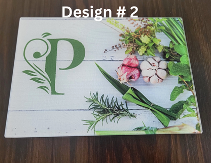 Design 2 with green letter 'P' and floral elements on a wooden surface