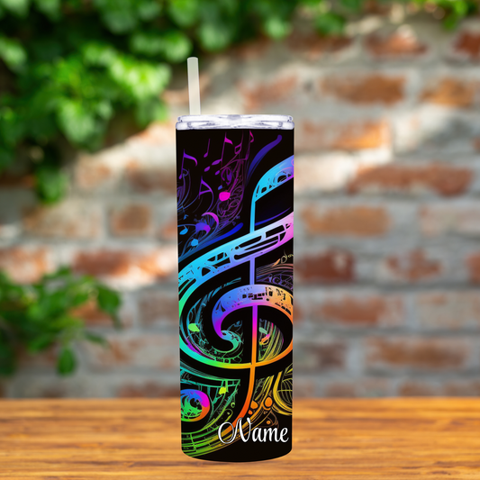 Tumbler with colorful musical note design on a wooden surface with a brick wall background