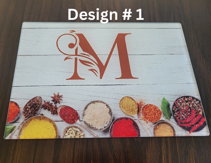 Wooden cutting board with a decorative 'M' design and colorful spices on a wooden surface.