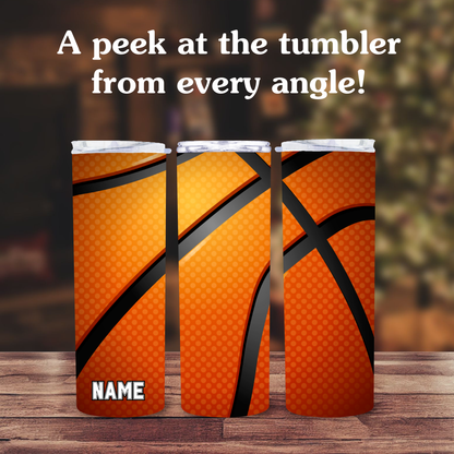 Three orange tumblers with basketball design on a wooden surface.