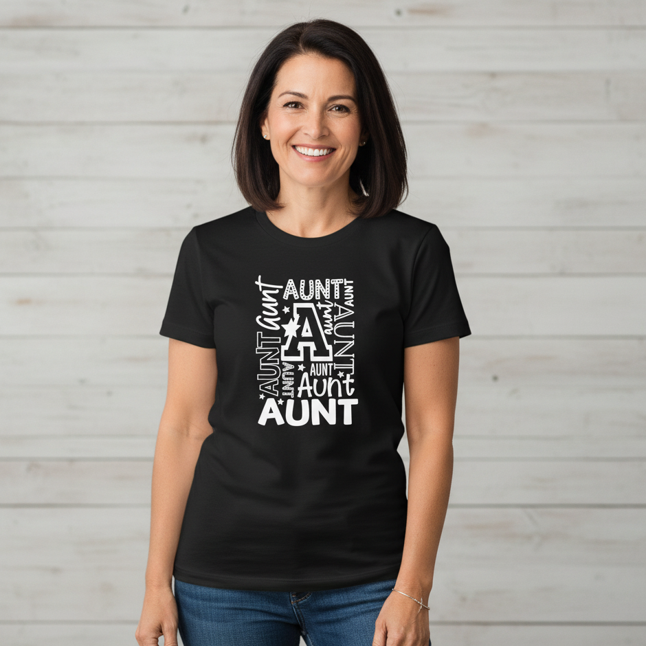 Woman wearing a black t-shirt with 'Aunt' text design against a light wooden panel background