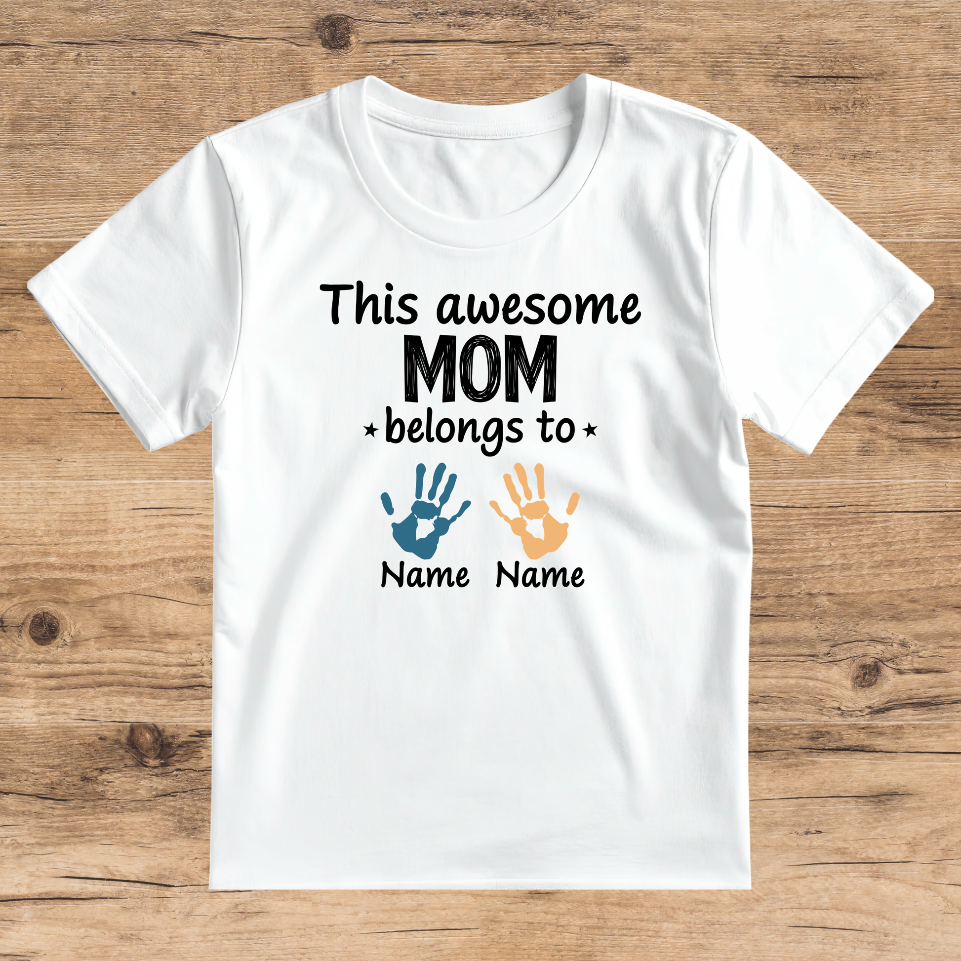 White t-shirt with text and handprints on a wooden surface