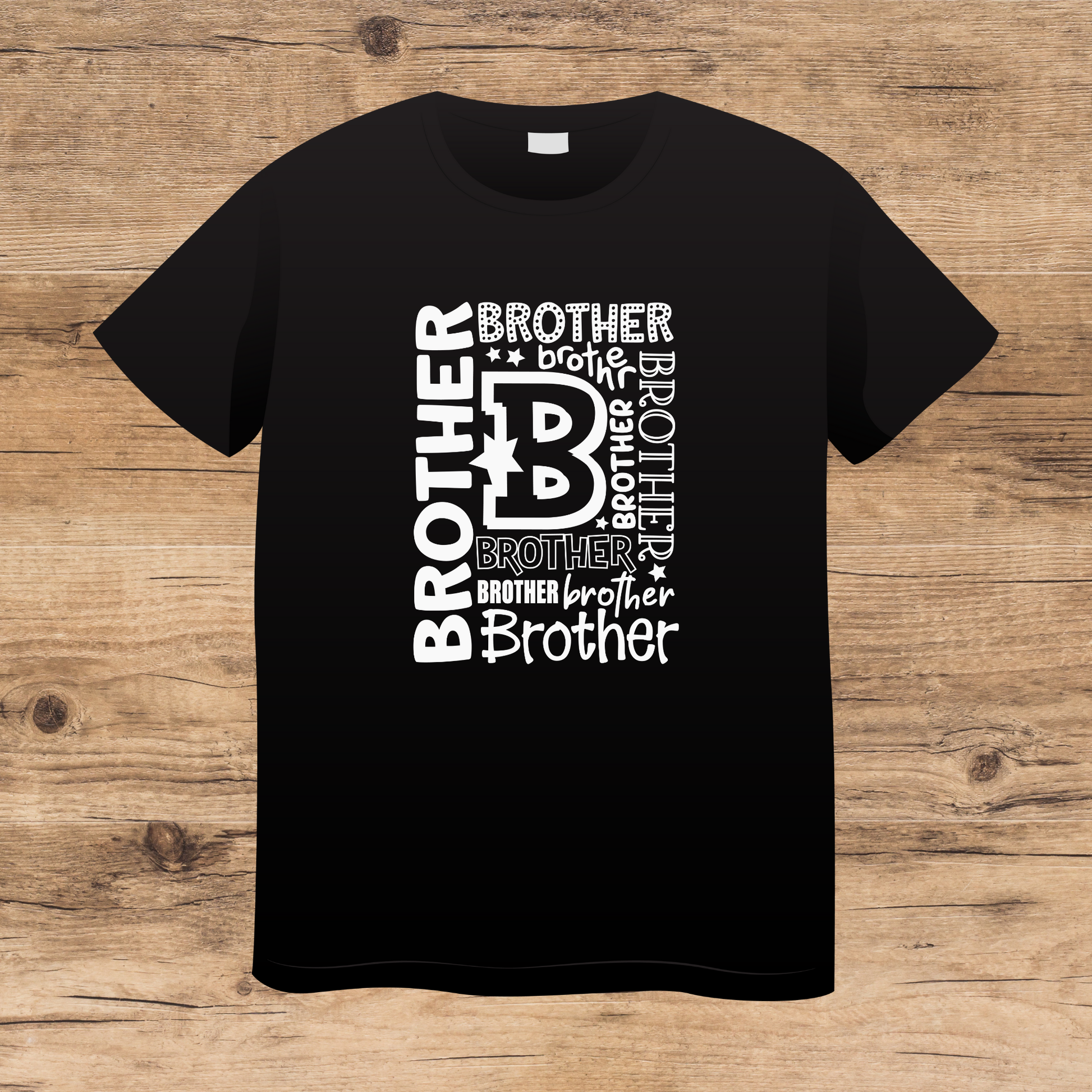 Black t-shirt with 'brother' text design on a wooden surface