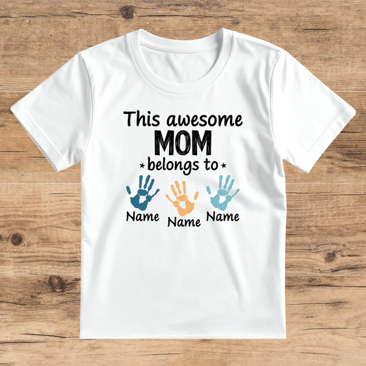 White t-shirt with text and hand print graphics on a wooden surface