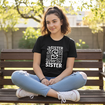 Black t-shirt with 'SISTER' text design on a wooden surface