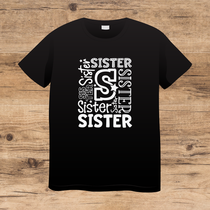 Black t-shirt with 'SISTER' text design on a wooden surface