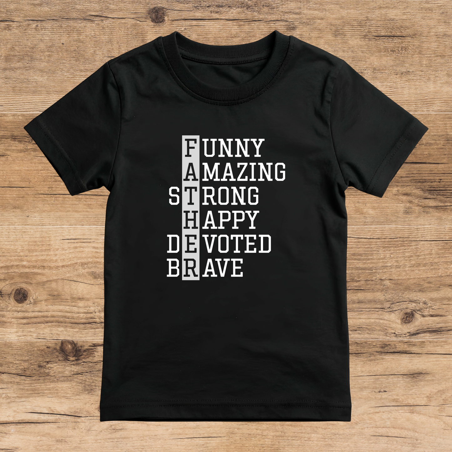 Black t-shirt with motivational text on a wooden surface