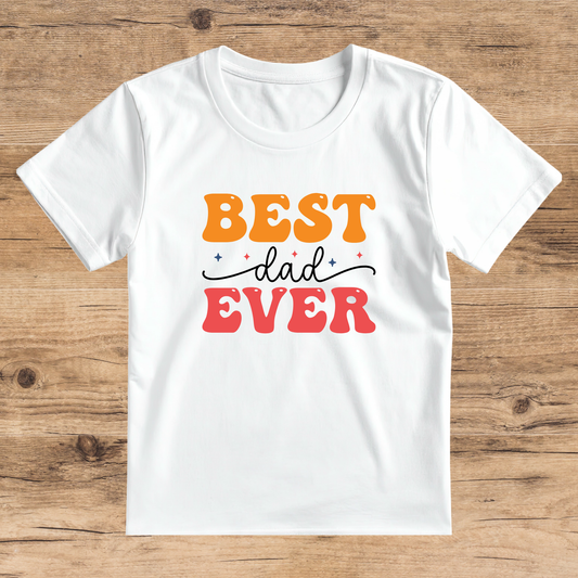 White t-shirt with 'BEST dad EVER' text on a wooden surface