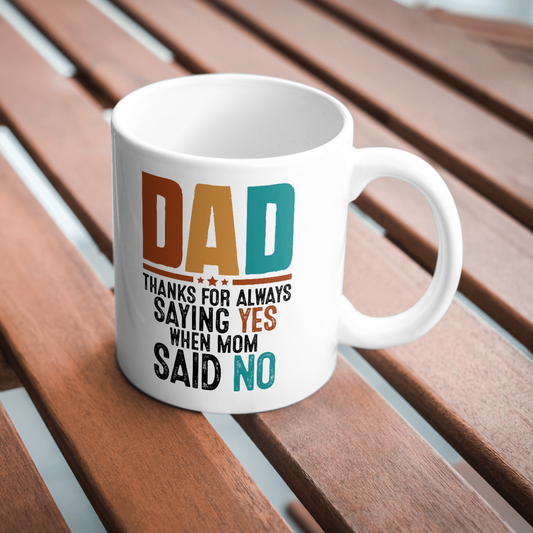 White mug with colorful text on a wooden surface