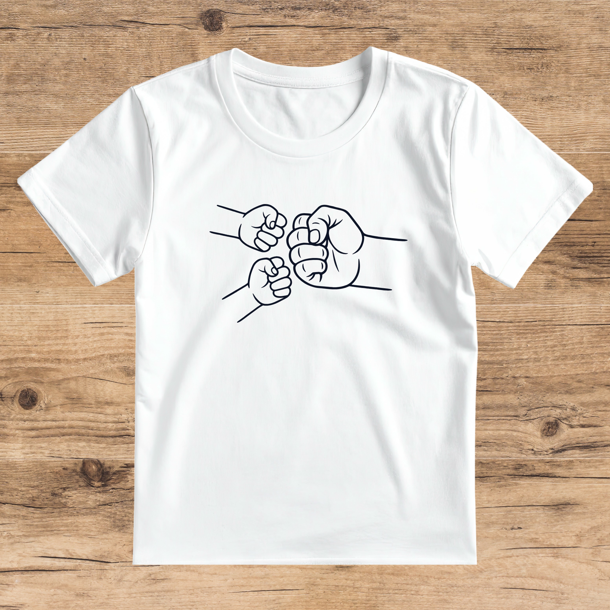 White t-shirt with black fist graphic on a wooden surface