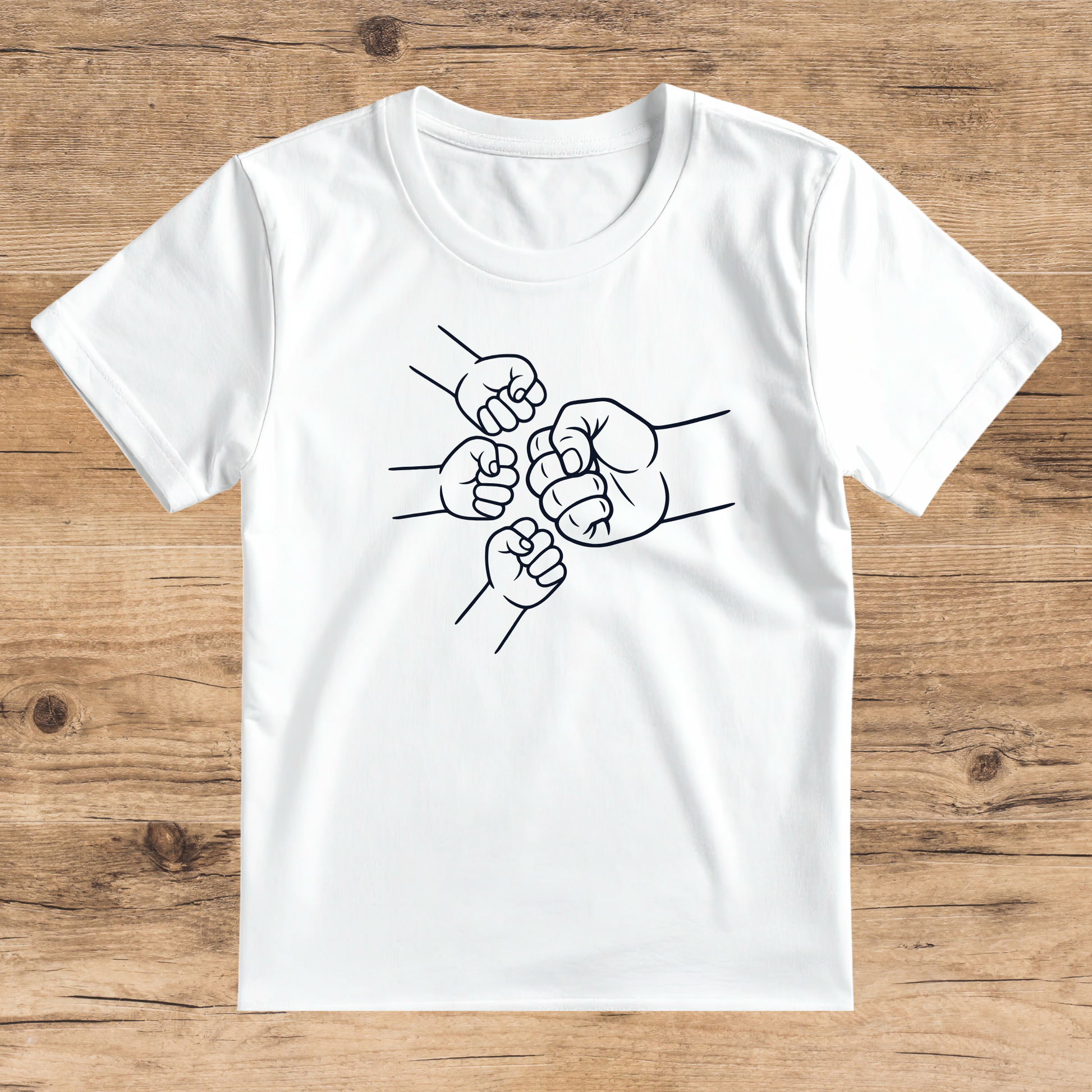 White t-shirt with black fist graphic on a wooden surface