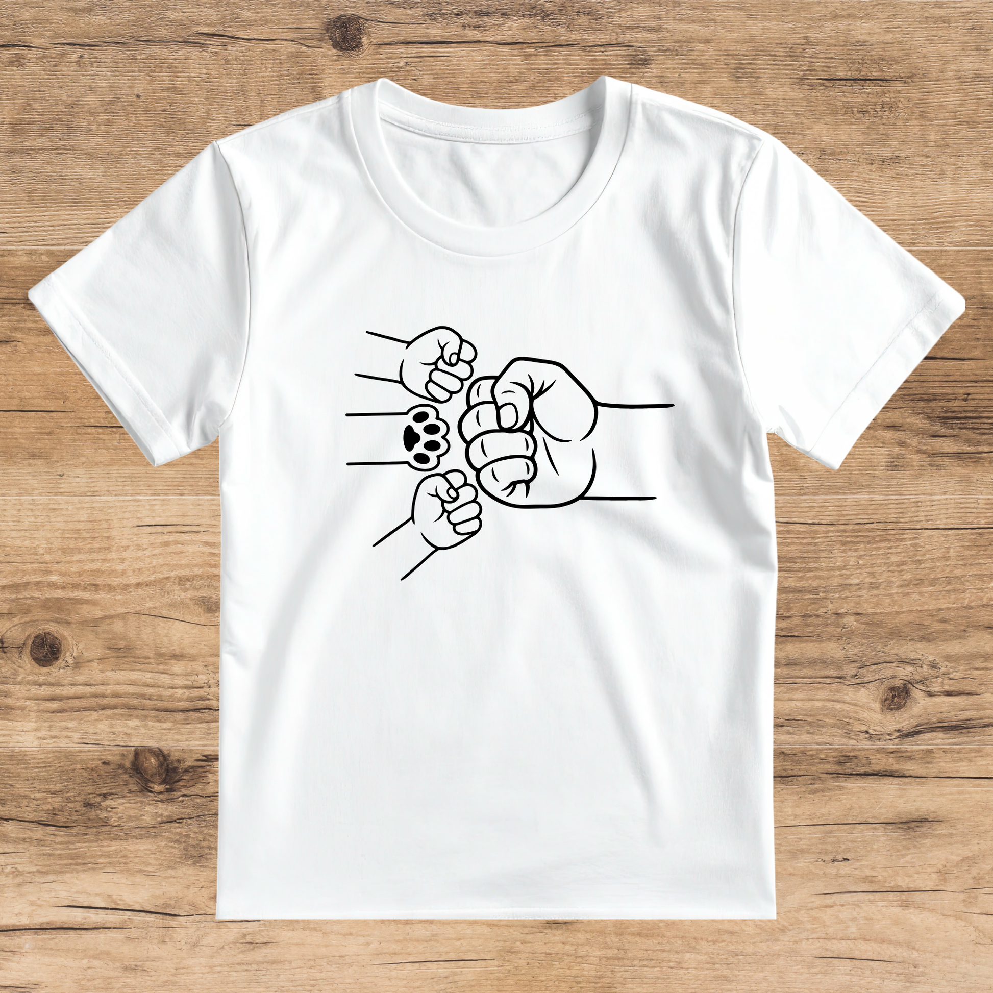 White t-shirt with black graphic of fists on a wooden surface