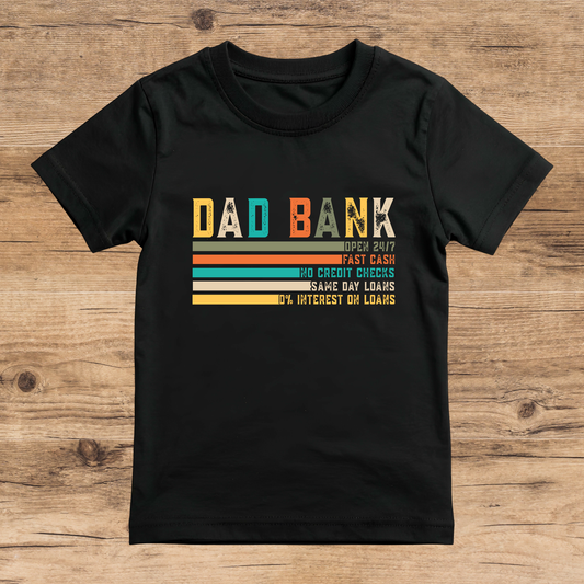 Black t-shirt with colorful text design on a wooden surface